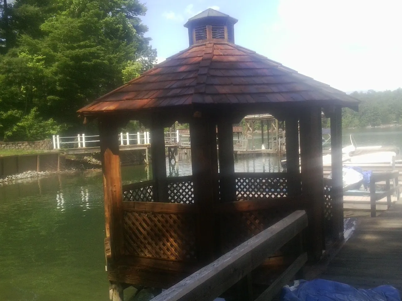 Cedar shake gazebo roof rebuilt on a lake dock in Kechi